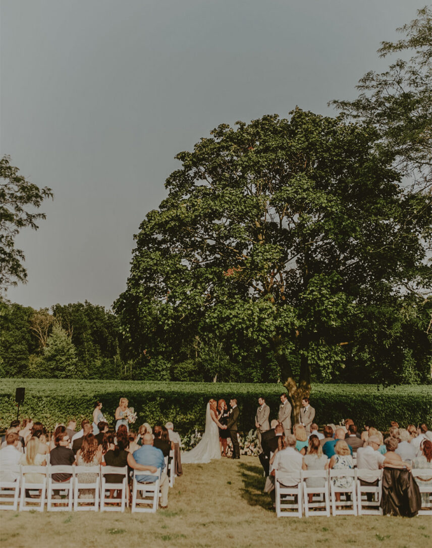 A couple getting married in the vineyards at The Hare Wine Co. in Niagara-on-the-Lake.