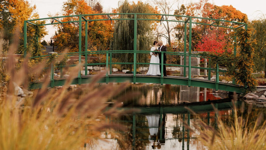 Outdoor fall wedding shoot on a bridge in the Gardens at Pillar and Post.