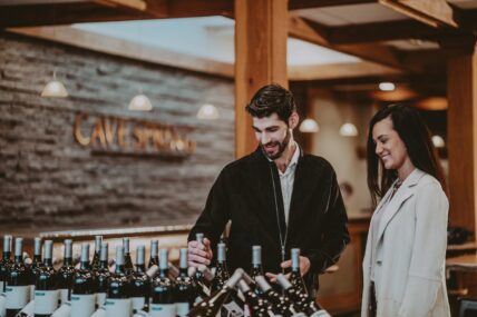 A couple visiting Cave Spring Vineyards on a wine tour.