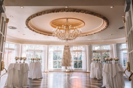 A crystal chandelier and classic drapery inside The Atrium at the Queen’s Landing hotel.