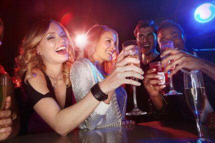 A group of friends toasting at the Icewine After Party inside the Pillar and Post hotel in Niagara-on-the-Lake.