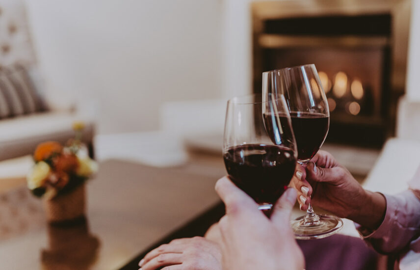 Two individuals toasting with wine at Inn On The Twenty in Jordan Village