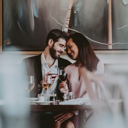 A couple enjoying wine with dinner at Inn On The Twenty Restaurant in Jordan Village