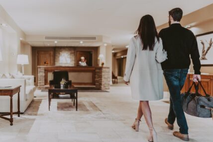 A couple walking into the Inn On The Twenty hotel in Jordan Village.