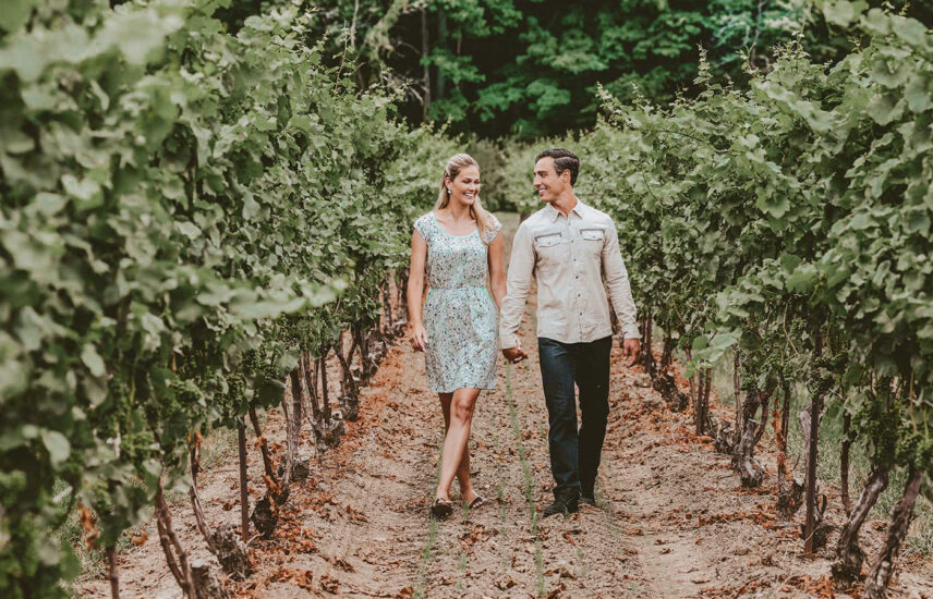 Couple wandering through vineyards at Inn On The Twenty in Jordan Village