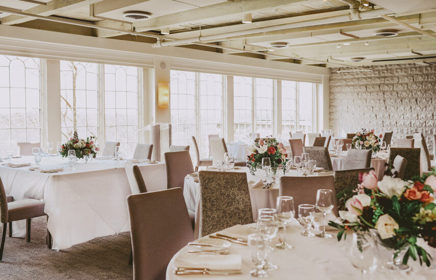 Reception table centerpieces at Windows On The Twenty wedding venue at Inn On The Twenty in Jordan Village
