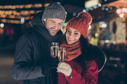 A couple drinking champagne in The Gardens during the Sip & Savour event.