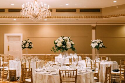 Guest tables set up at a wedding inside the Queen’s Landing hotel.