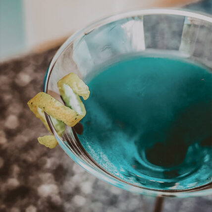 Blue cocktail mixed in Headwaters Lounge & Patio at Millcroft Inn & Spa in Caledon