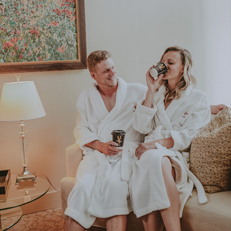 A couple sipping hot coffees on their spa retreat in Caledon, Ontario.
