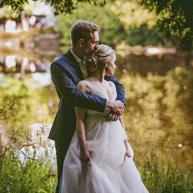 Newlyweds embracing outside of Millcroft Inn & Spa, a wedding venue in Caledon, Ontario.