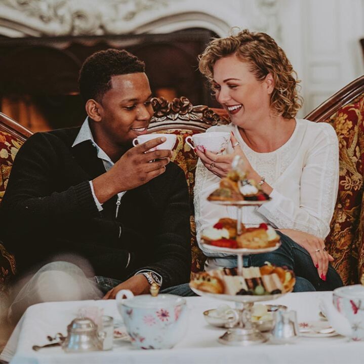 A couple enjoying tea in The Drawing Room at the Prince of Wales hotel in Niagara-on-the-Lake.