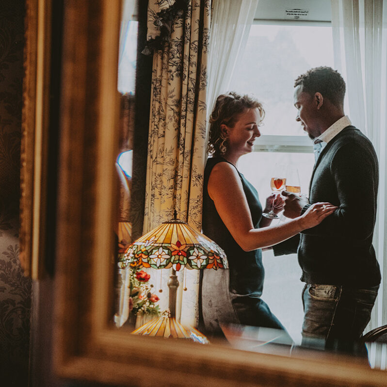 Couple sharing an intimate moment in their accommodations at the Prince of Wales Hotel in Niagara-on-the-Lake