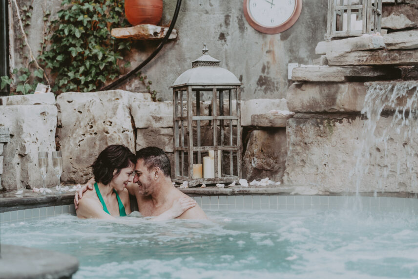 A couple relaxing in the hot spring pool at 100 Fountain Spa in Niagara-on-the-Lake.
