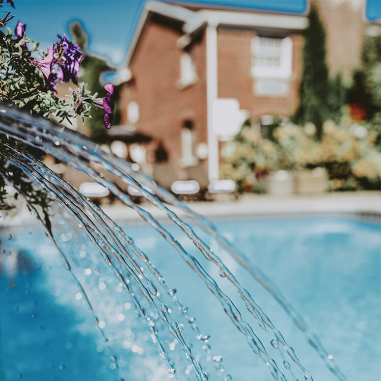 Poolside Patio in-pool waterfall at the Pillar & Post Hotel in Niagara-on-the-Lake