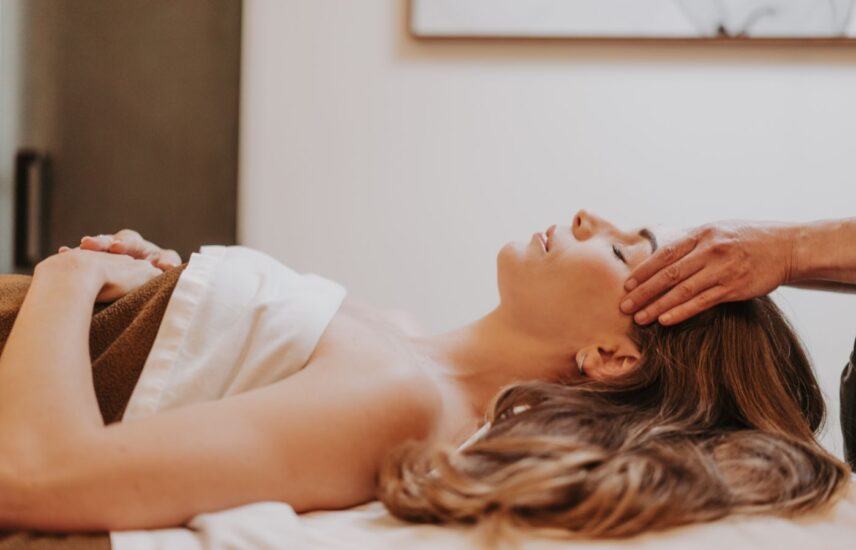 A person receiving a facial spa treatment at 100 fountain spa