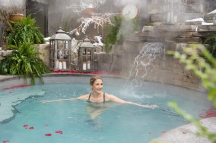 A woman relaxing in the hot spring pool at 100 Fountain Spa in Niagara-on-the-Lake.