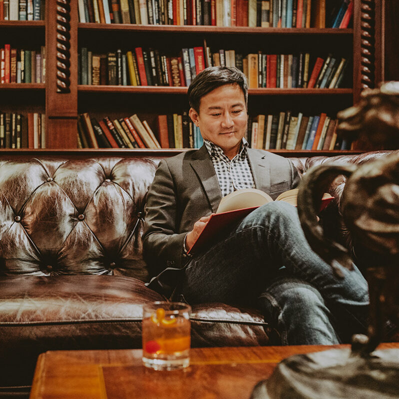 Guest enjoying ornate library at Queen's Landing in Niagara-on-the-Lake