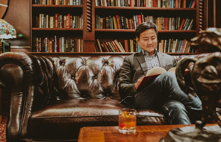 Guest enjoying the Queen's Landing library during their stay in Niagara-on-the-Lake