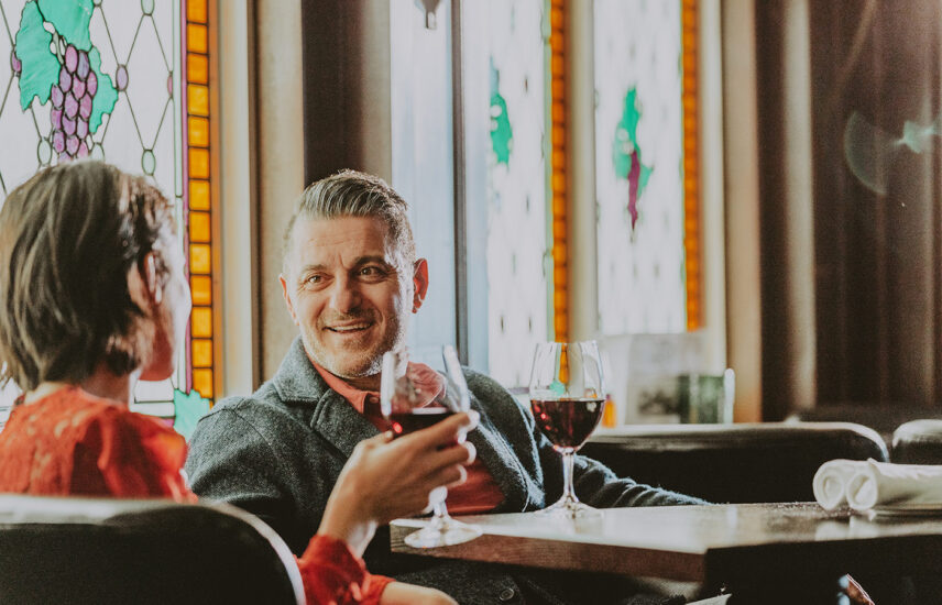 Couple enjoying drinks at Bacchus Lounge during stay at Queen's Landing