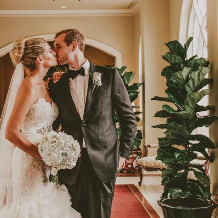 A couple kissing in the foyer after getting married at the Queen’s Landing hotel in Niagara-on-the-Lake.