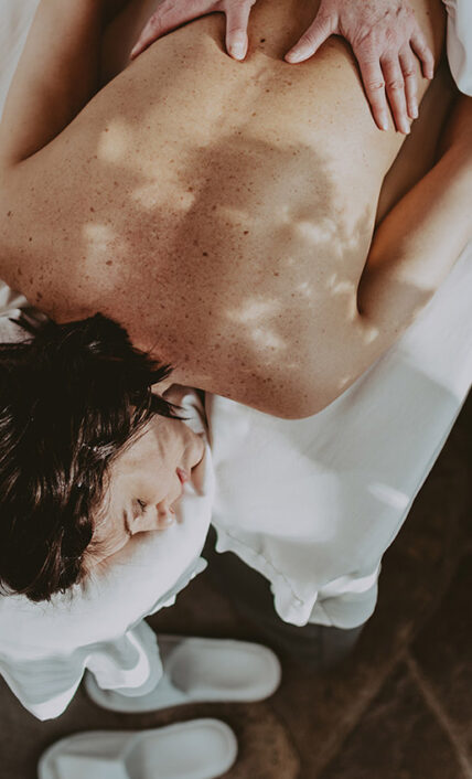 A woman receiving a relaxing massage at 100 Fountain Spa, a spa near Queen's Landing.