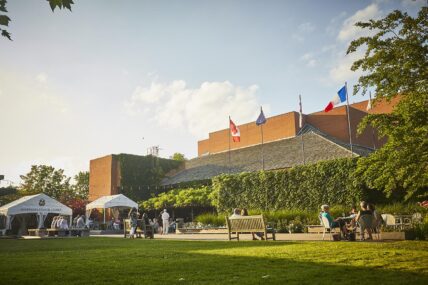 People sitting outside of the Shaw Festival Theatre.
