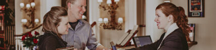 Staff member at Vintage Hotels helping guests