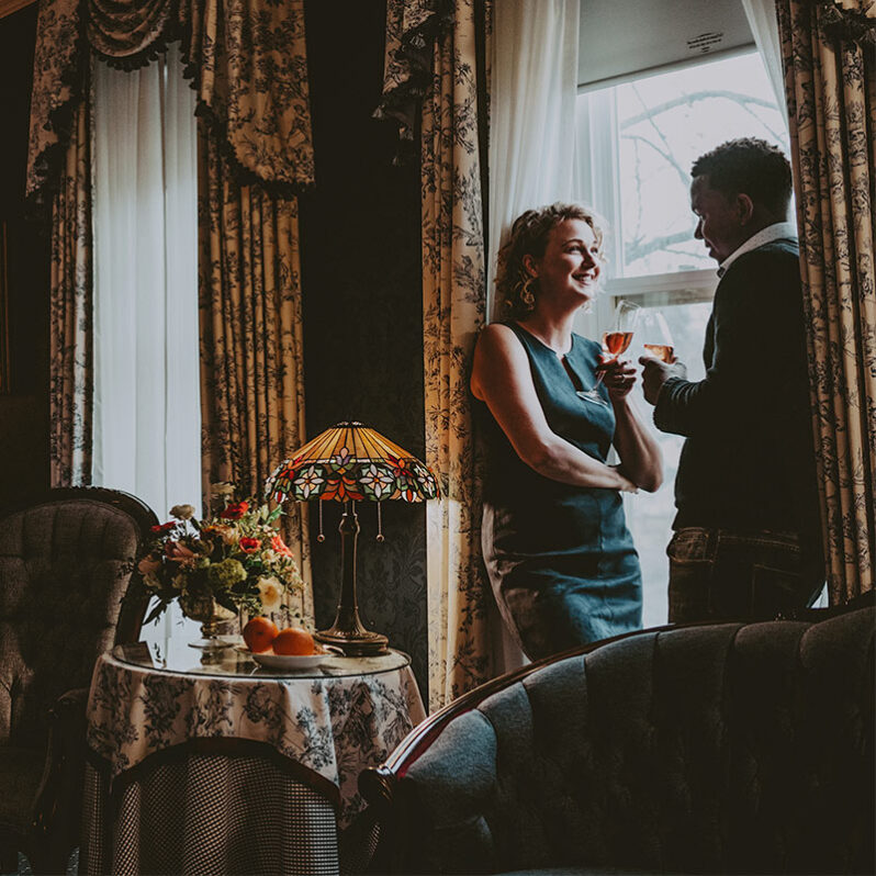 Couple enjoying a hotel room at Prince of Wales in Niagara on the Lake
