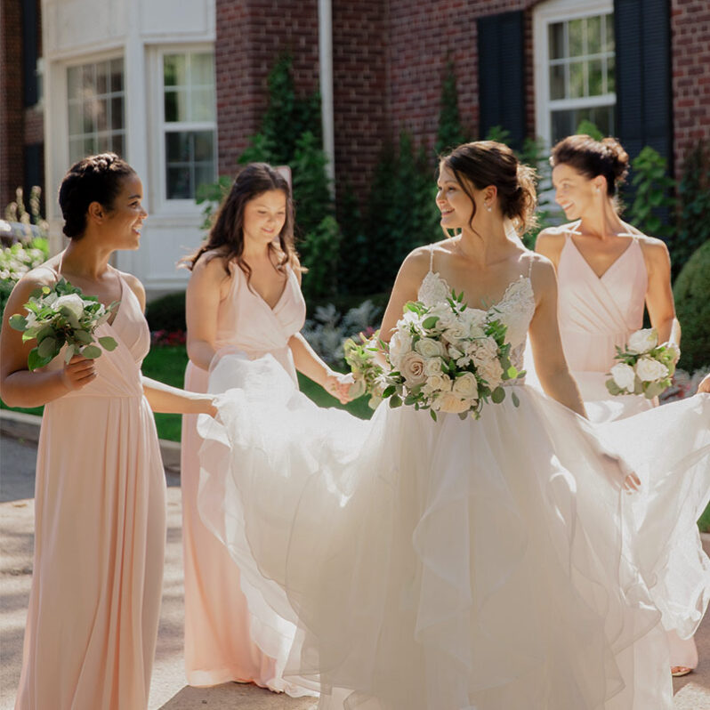 Bridesmaids walking at an Ontario wedding venue