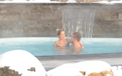 A couple enjoying the hot springs in Caledon.