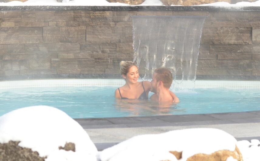 A couple enjoying the hot springs in Caledon.
