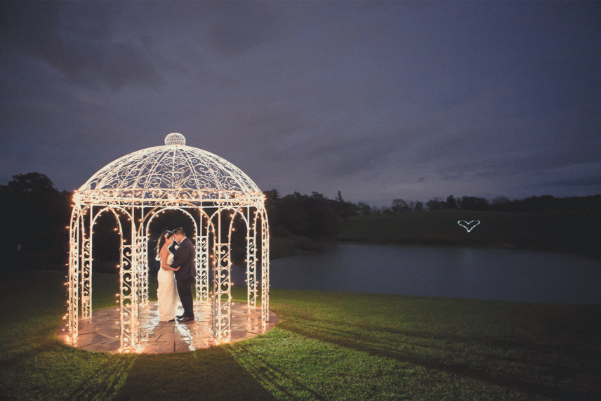 Couple under wedding gazebo at sue ann staff estate winery