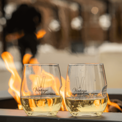 Vintage Hotels glasses on wine by a fire pit in Niagara-on-the-Lake, Ontario.