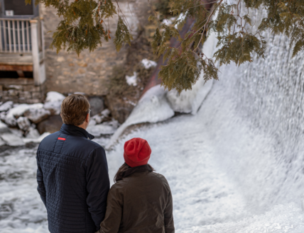 A couple exploring Millcroft's grounds during the winter.